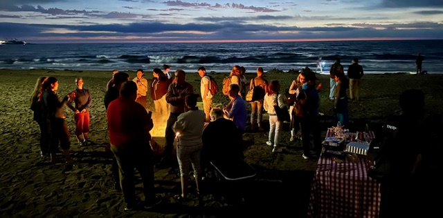 Evening beach gathering at sunset