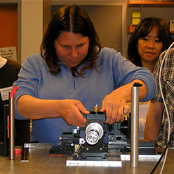 Instructor working on flow cytometer optical bench, 2008