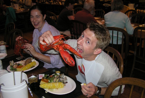 Course participant holding a Maine lobster at dinner, 2008