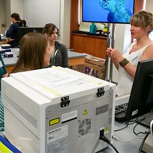 Students discussing around a cytometer