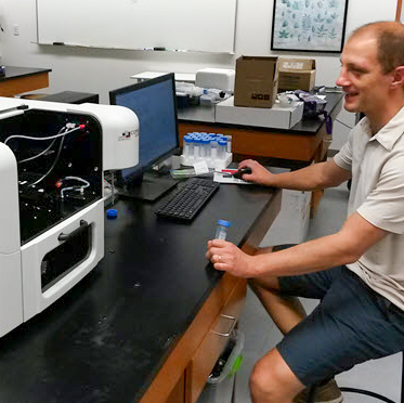 Instructor at a flow cytometer in a teaching lab